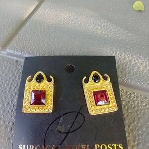 Women's gold and red decorative post earrings.